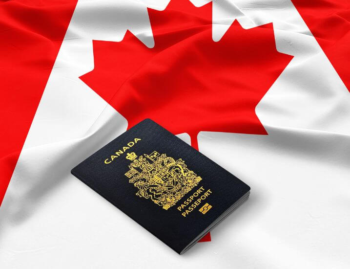 canadian flag with a canadian passport lying on top of it
